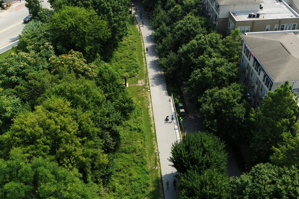 Aerial view of Atlanta BeltLine paved bike trail surrounded by green trees